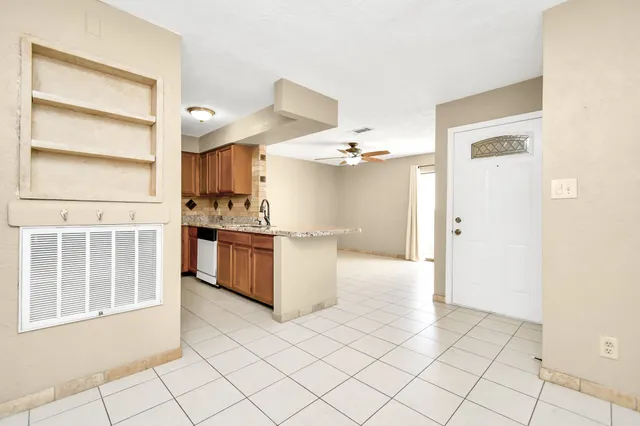 a kitchen with stainless steel appliances a stove top oven and cabinets