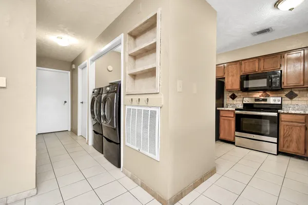 a kitchen with stainless steel appliances a refrigerator and a stove top oven