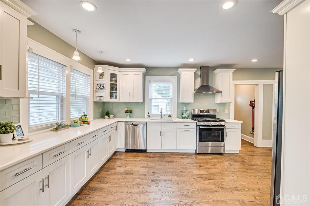79 Van Ness Terrace Maplewood, NJ 07040 - Photo 11 of 40 a large kitchen with stainless steel appliances granite countertop a stove and a sink