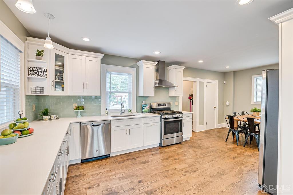 79 Van Ness Terrace Maplewood, NJ 07040 - Photo 12 of 40 a large kitchen with cabinets chairs and a stove top oven
