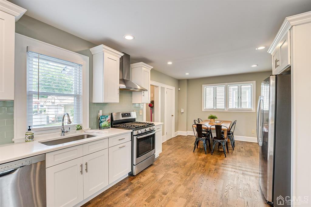 79 Van Ness Terrace Maplewood, NJ 07040 - Photo 13 of 40 a kitchen with a table chairs stove and cabinets