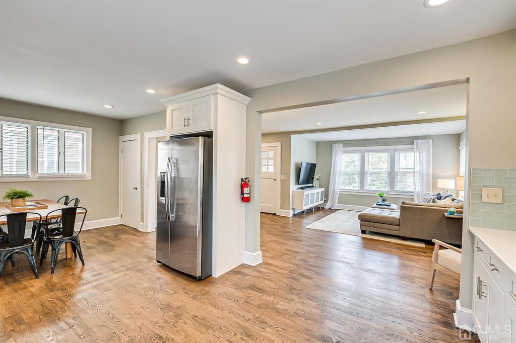 79 Van Ness Terrace Maplewood, NJ 07040 - Photo 14 of 40 a living room with furniture and a dining table with kitchen view