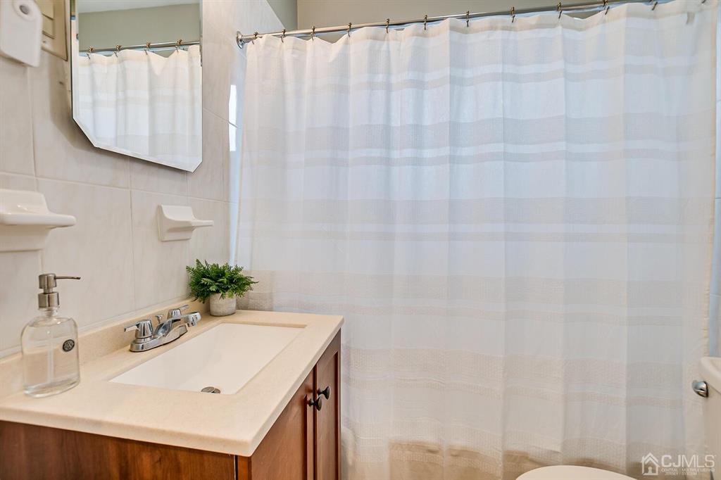 79 Van Ness Terrace Maplewood, NJ 07040 - Photo 22 of 40 a bathroom with a sink and a mirror