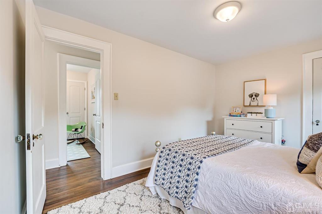79 Van Ness Terrace Maplewood, NJ 07040 - Photo 28 of 40 a bedroom with a bed and wooden floor