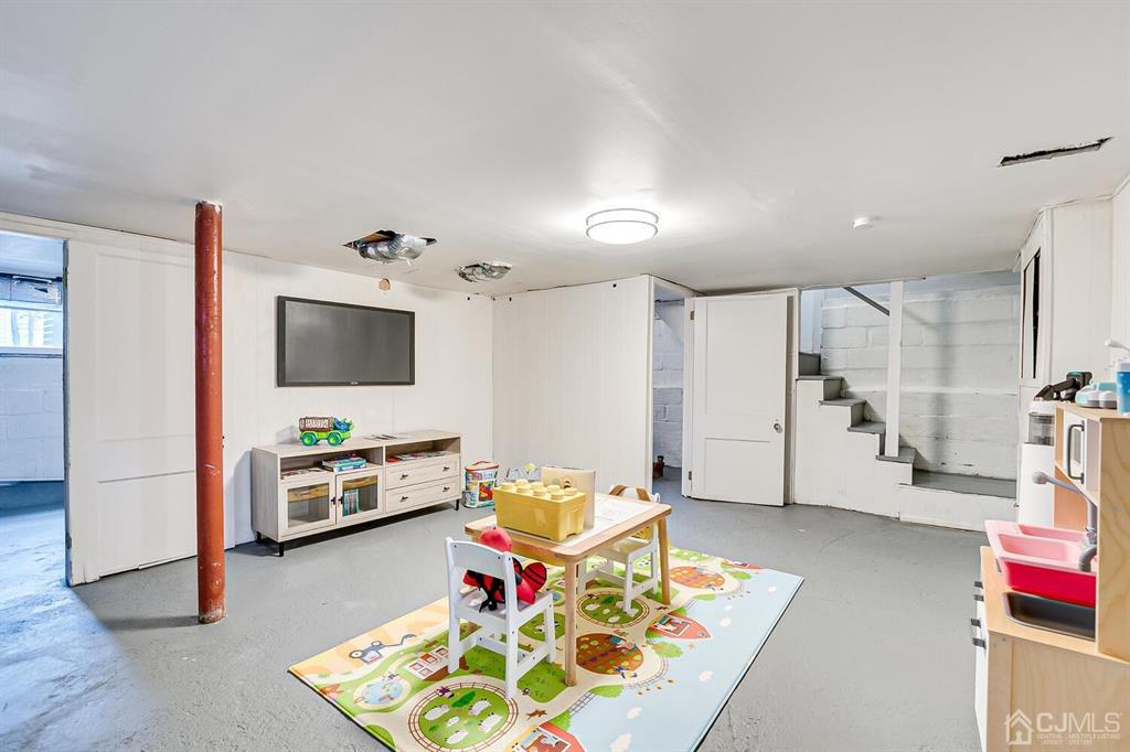 79 Van Ness Terrace Maplewood, NJ 07040 - Photo 33 of 40 a living room with furniture and a flat screen tv