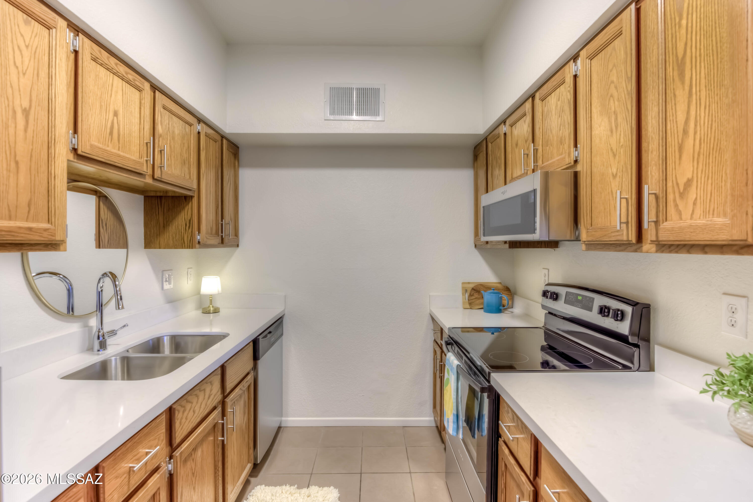 5500 North Valley View Road, Unit 123 Tucson, AZ 85718 - Photo 20 of 36 a kitchen with stainless steel appliances granite countertop a sink and a stove