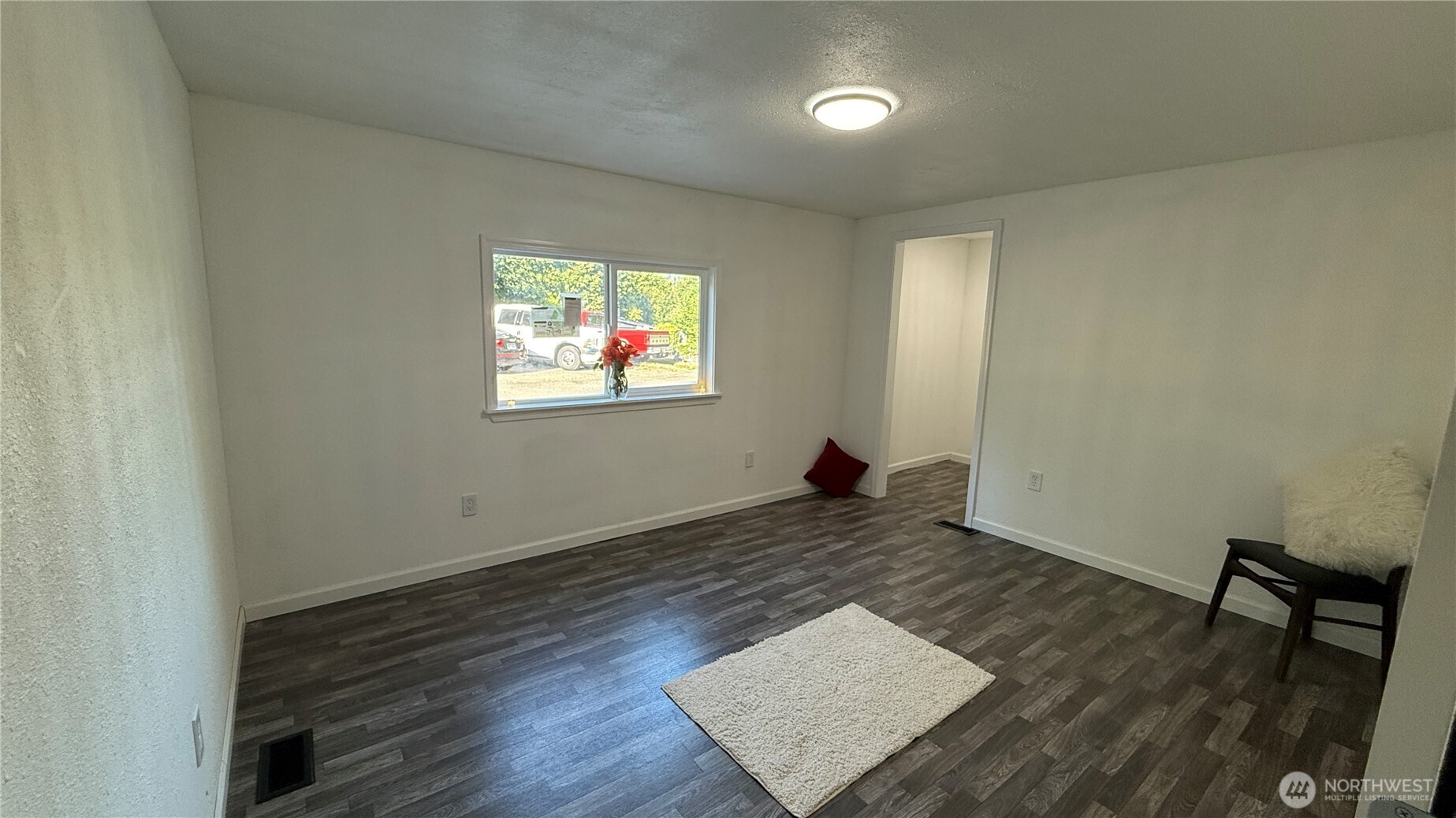 11517 155th Avenue Southeast Renton, WA 98059 - Photo 7 of 17 an empty room with wooden floor and windows