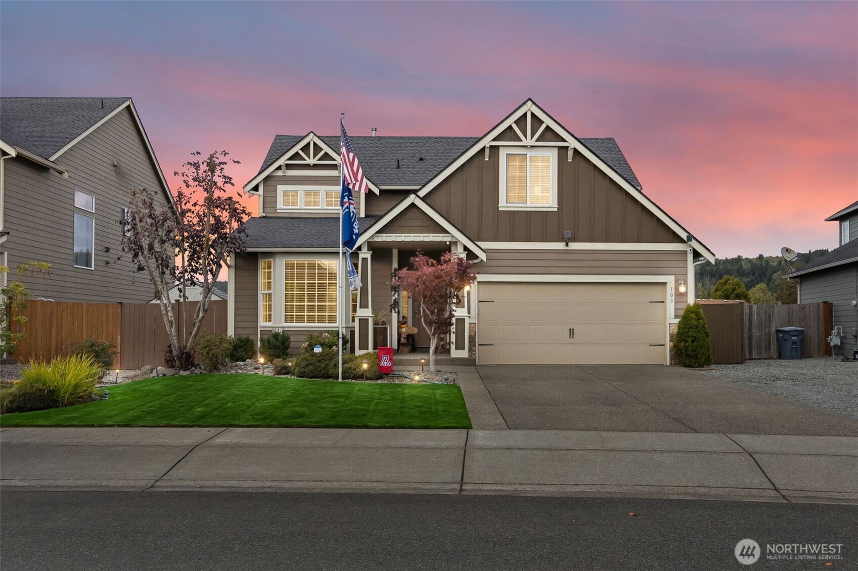103 Balmer Street Southwest Orting, WA 98360 - Photo 1 of 30 a front view of a house with a yard and garage