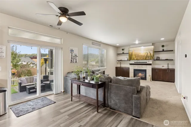 a living room with fireplace furniture and a wooden floor