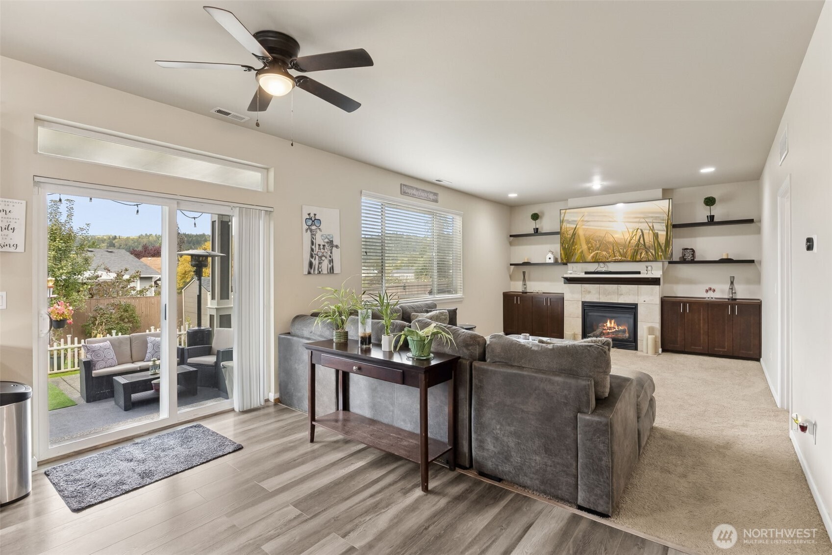 103 Balmer Street Southwest Orting, WA 98360 - Photo 11 of 30 a living room with fireplace furniture and a wooden floor