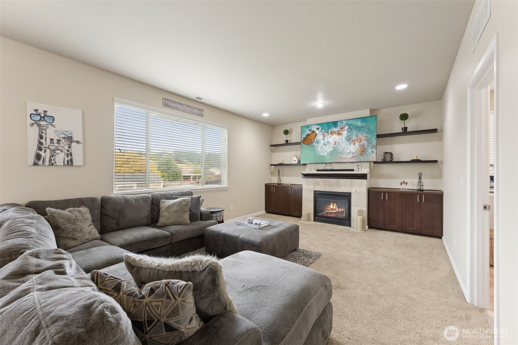 103 Balmer Street Southwest Orting, WA 98360 - Photo 12 of 30 a living room with furniture a fireplace and a large window