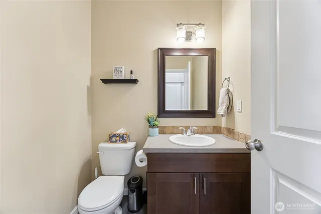 a bathroom with a sink a toilet and mirror