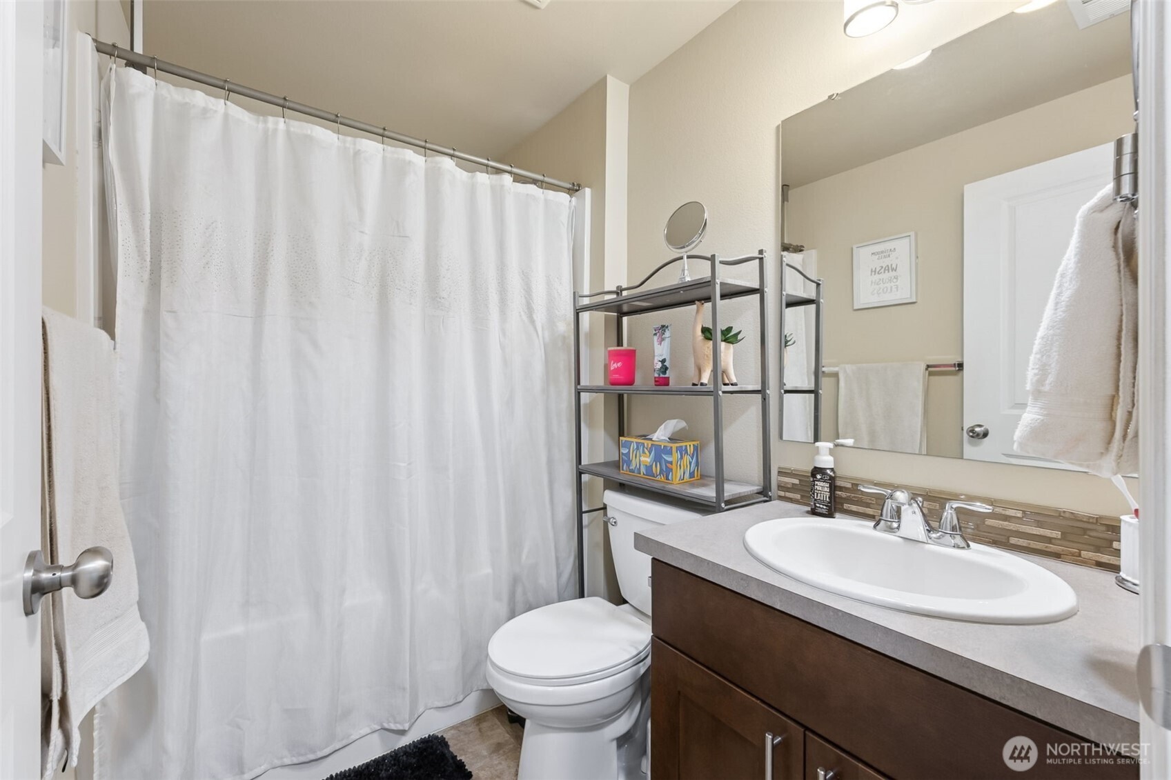 103 Balmer Street Southwest Orting, WA 98360 - Photo 24 of 30 a bathroom with a granite countertop sink toilet and a mirror