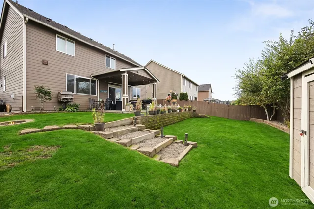 a backyard of a house with table and chairs
