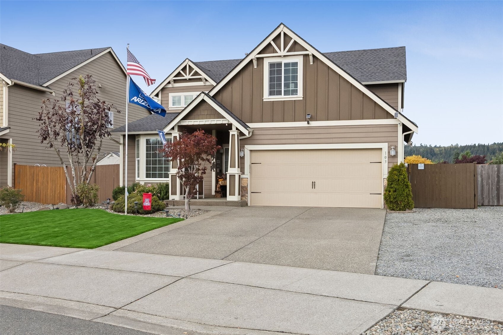 103 Balmer Street Southwest Orting, WA 98360 - Photo 30 of 30 a front view of a house with a yard and garage