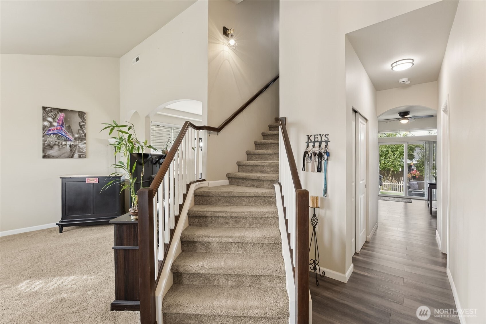 103 Balmer Street Southwest Orting, WA 98360 - Photo 4 of 30 a view of staircase with lots of frames and frames on wall and wooden floor