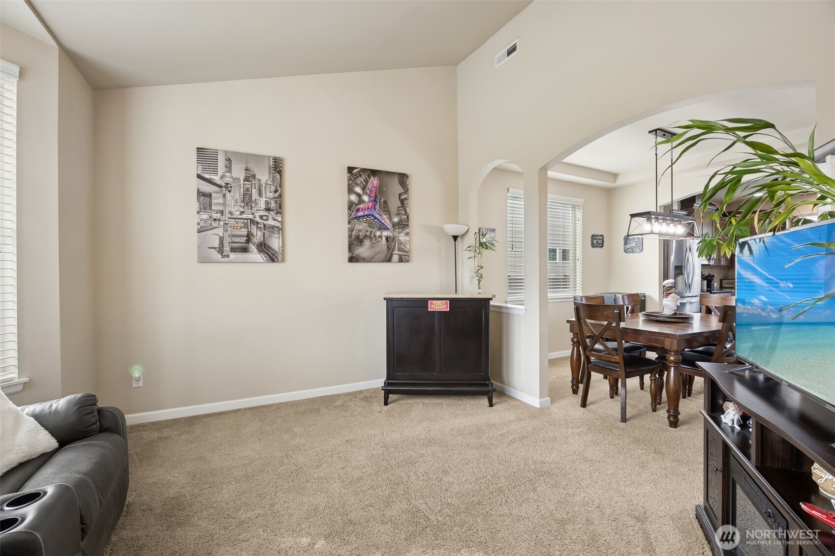 103 Balmer Street Southwest Orting, WA 98360 - Photo 6 of 30 a living room with furniture a dining table and paintings on the wall
