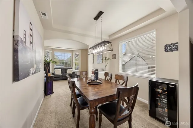 a view of a dining room with furniture and chandelier
