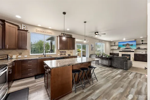 a large kitchen with lots of counter space dining table and stainless steel appliances