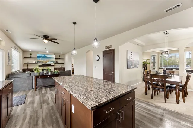 a kitchen with stainless steel appliances granite countertop sink stove top oven and cabinets