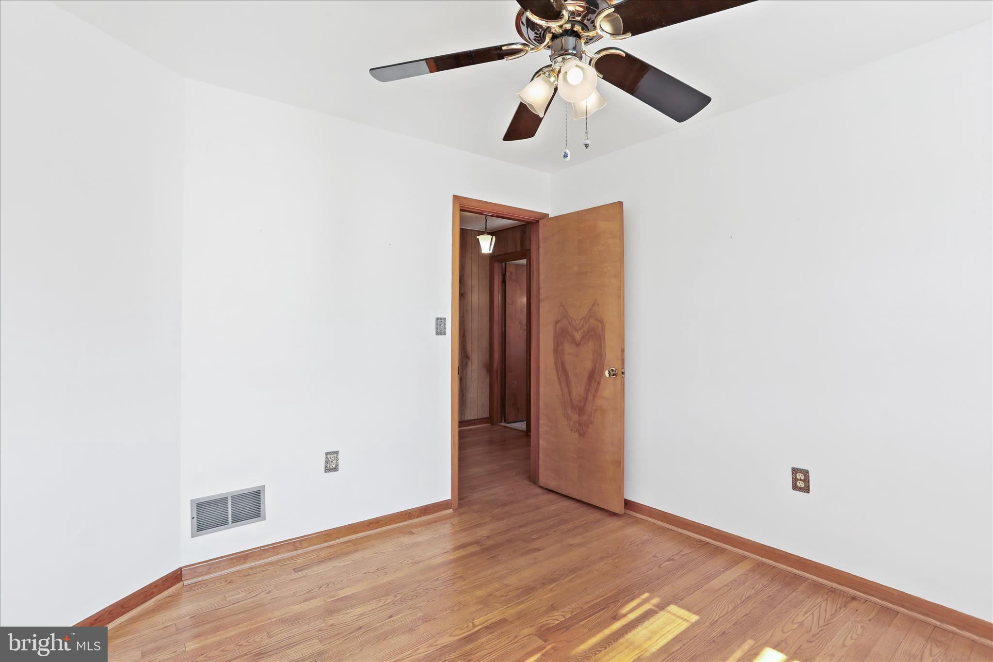 550 Bucks Mill Road Strasburg, VA 22657 - Photo 19 of 57 an empty room with wooden floor closet and fan