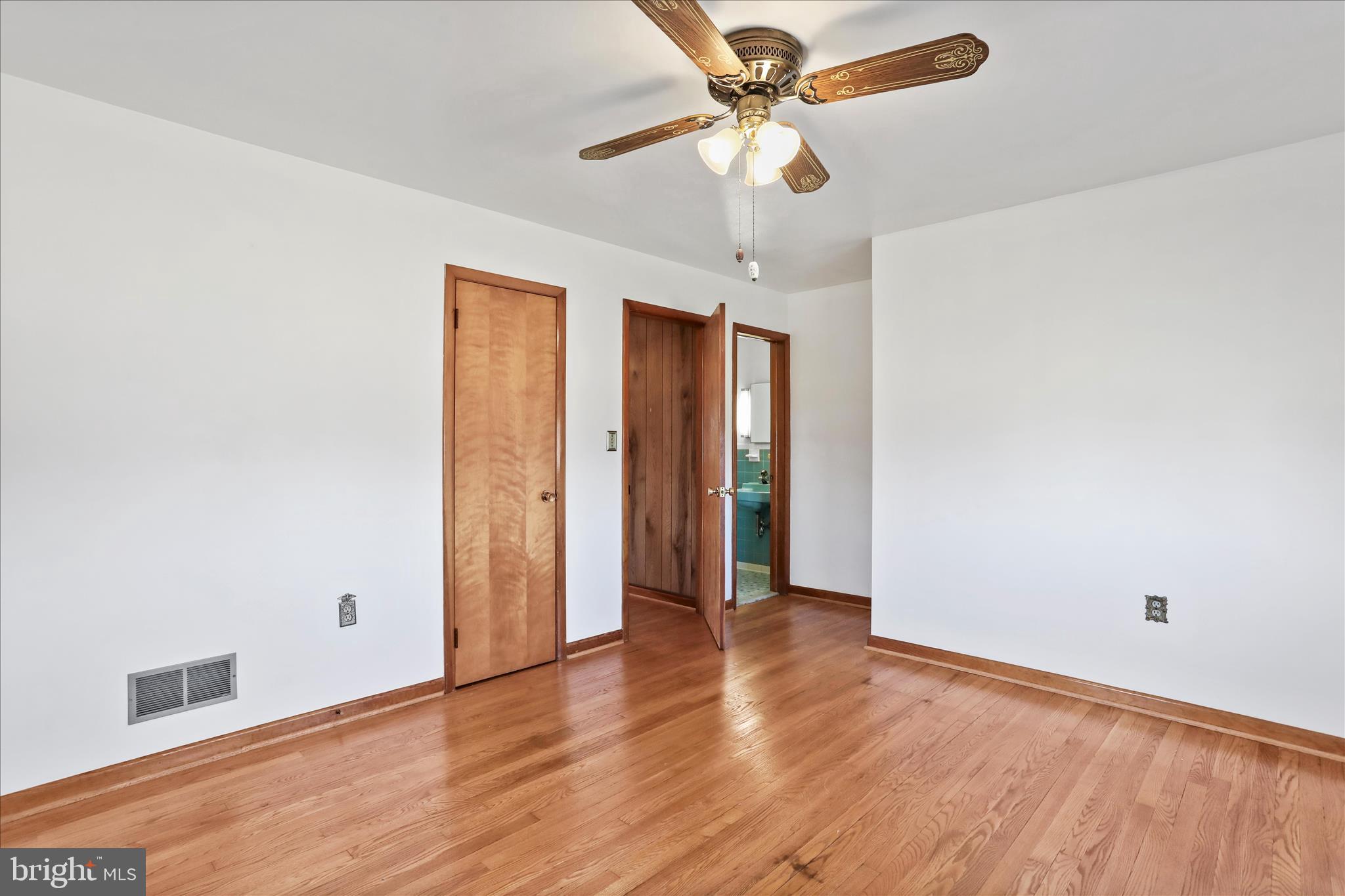 550 Bucks Mill Road Strasburg, VA 22657 - Photo 25 of 57 an empty room with wooden floor and ceiling fan