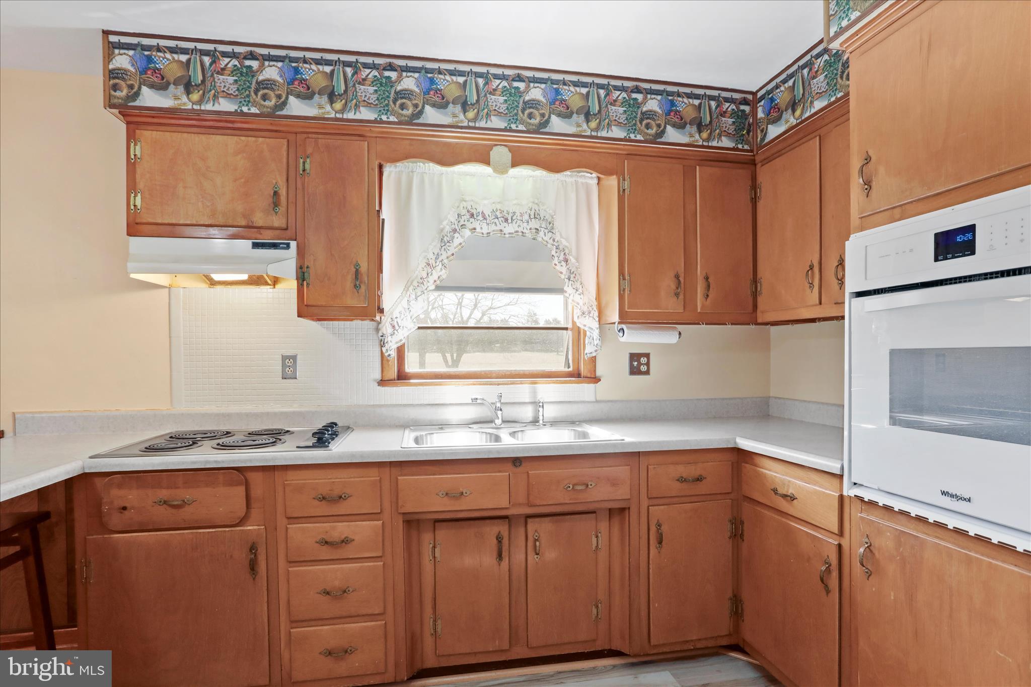 550 Bucks Mill Road Strasburg, VA 22657 - Photo 8 of 57 a kitchen with granite countertop a sink window and cabinets