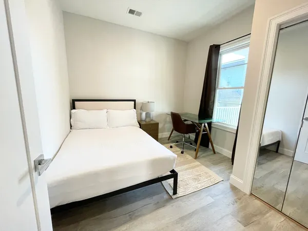 a bedroom with a bed and a rug