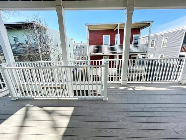 a view of a balcony with wooden floor