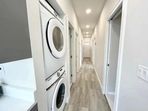 a view of a hallway with washer and dryer