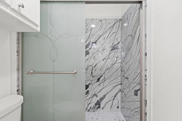 a bathroom with a shower curtain and a toilet