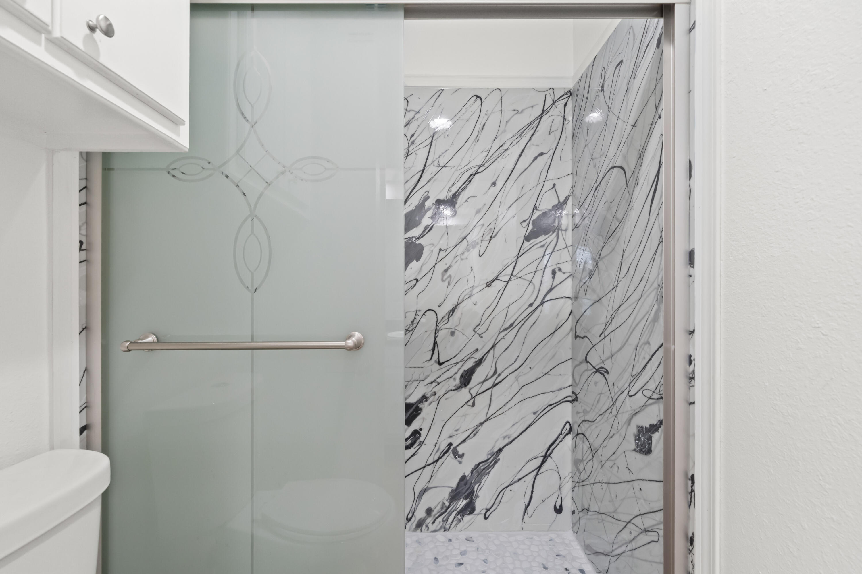 6201 5th Street Lubbock, TX 79416 - Photo 11 of 25 a bathroom with a shower curtain and a toilet