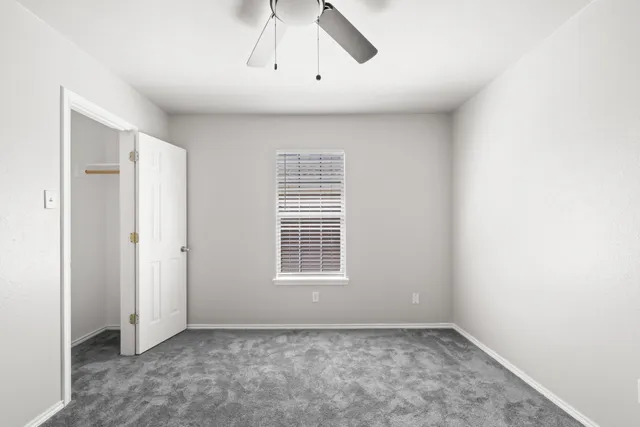 a view of an empty room with a window