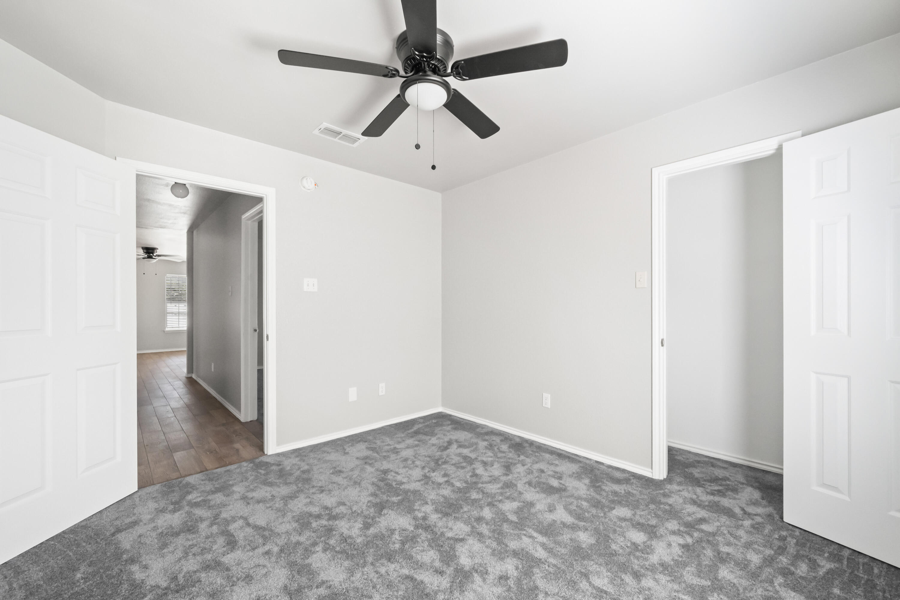 6201 5th Street Lubbock, TX 79416 - Photo 15 of 25 an empty room with a ceiling fan and carpet