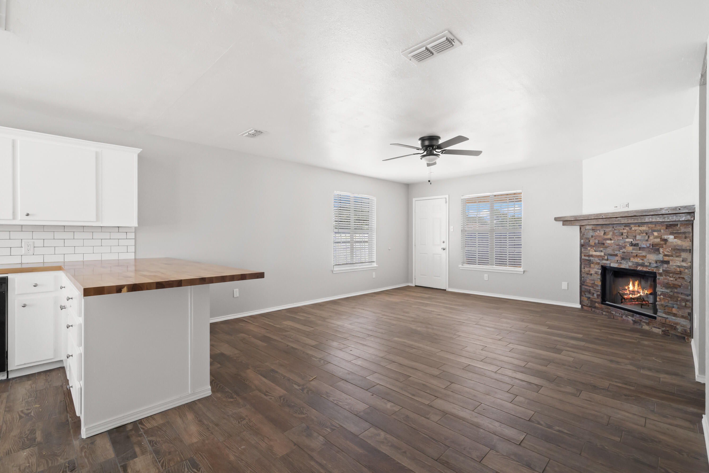 6201 5th Street Lubbock, TX 79416 - Photo 21 of 25 wooden floor in an empty room with a fireplace