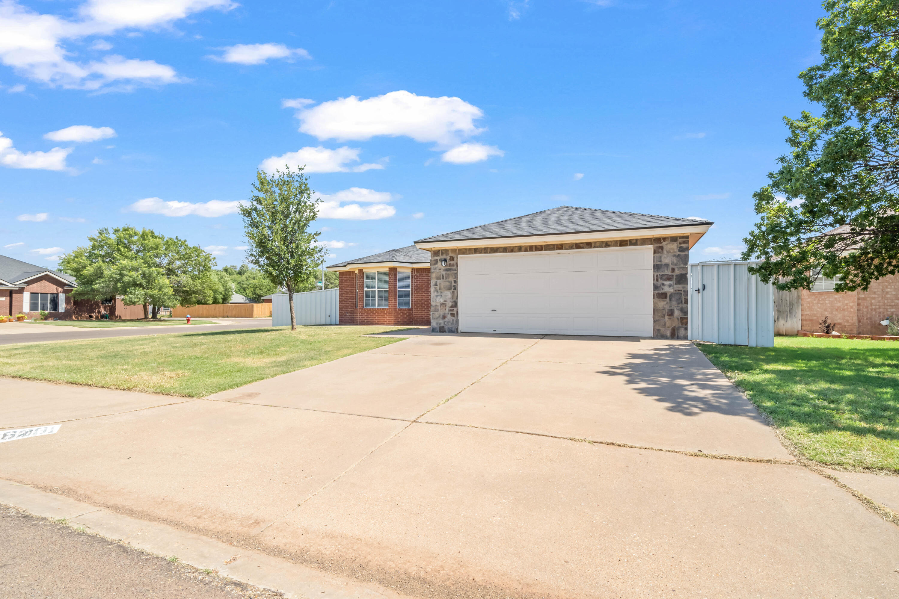 6201 5th Street Lubbock, TX 79416 - Photo 25 of 25 a view of yellow house with a yard