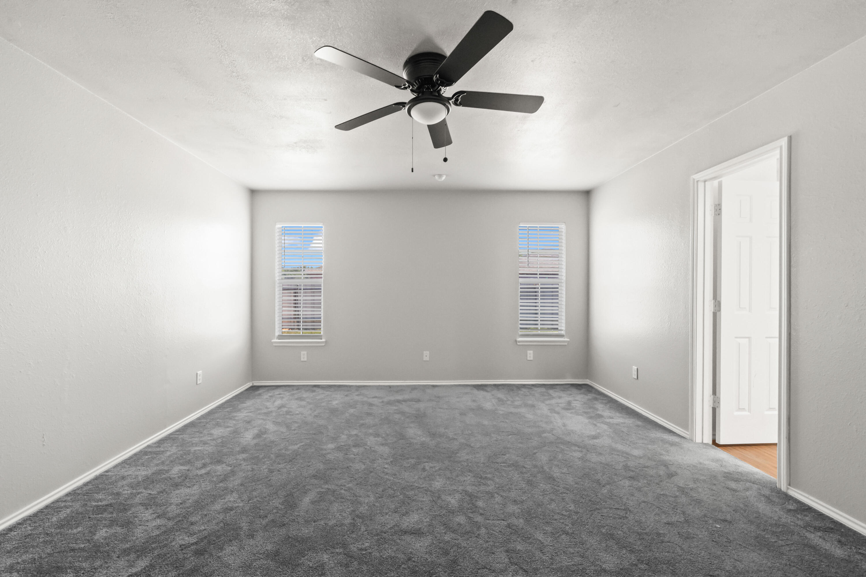 6201 5th Street Lubbock, TX 79416 - Photo 7 of 25 a view of an empty room with a ceiling fan