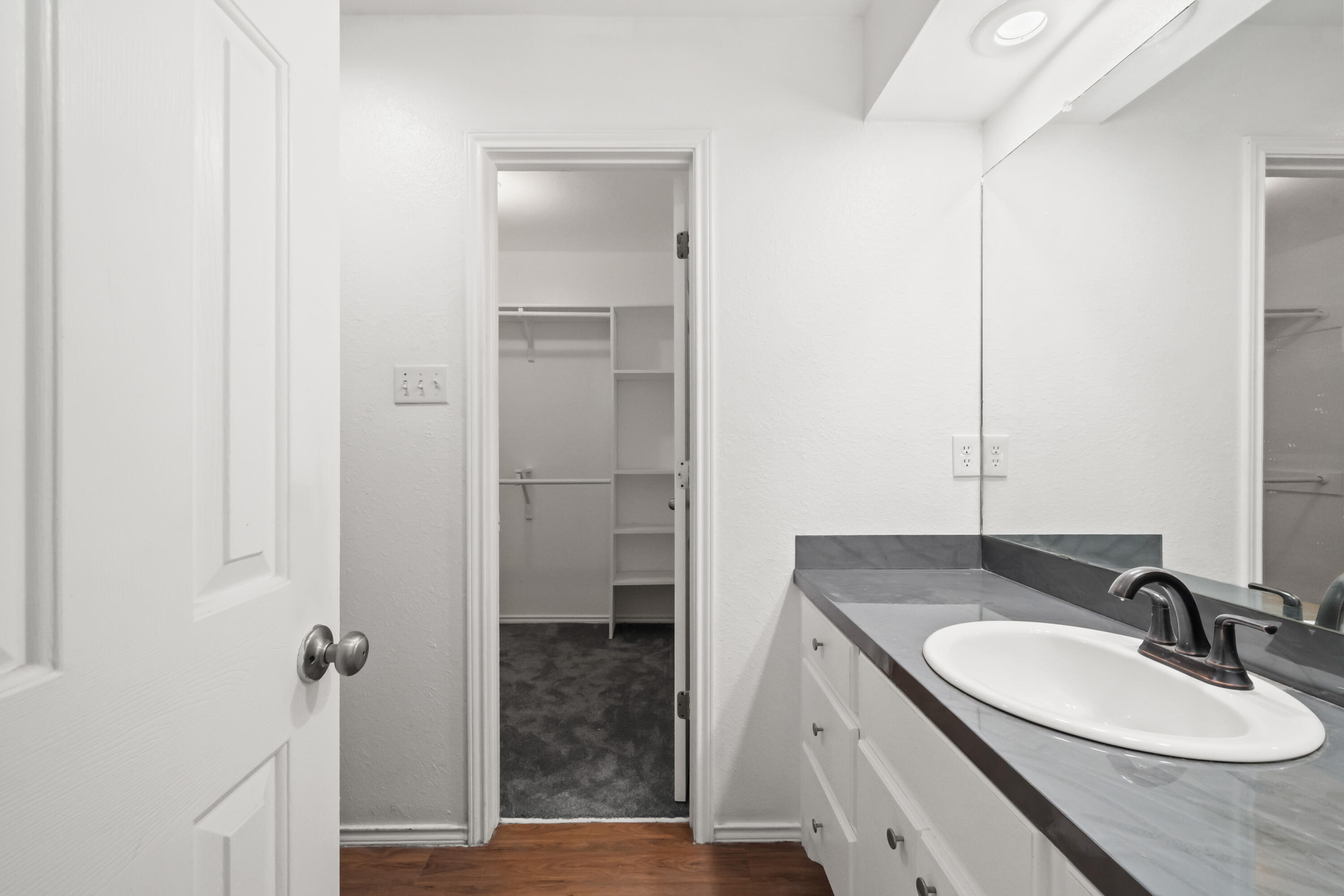 6201 5th Street Lubbock, TX 79416 - Photo 9 of 25 a bathroom with a sink and a mirror