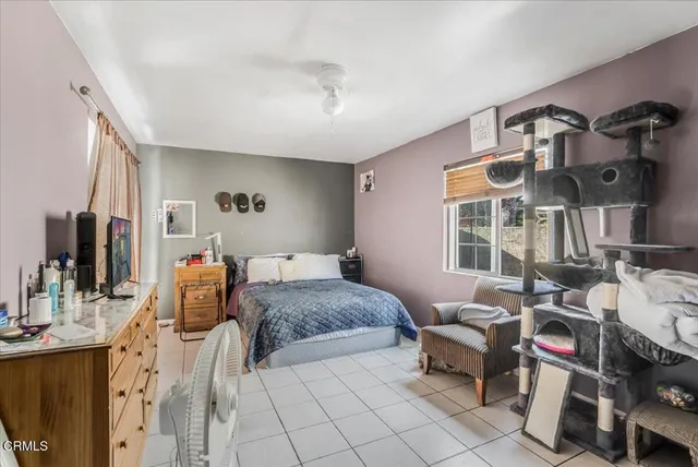 a bedroom with furniture and a window