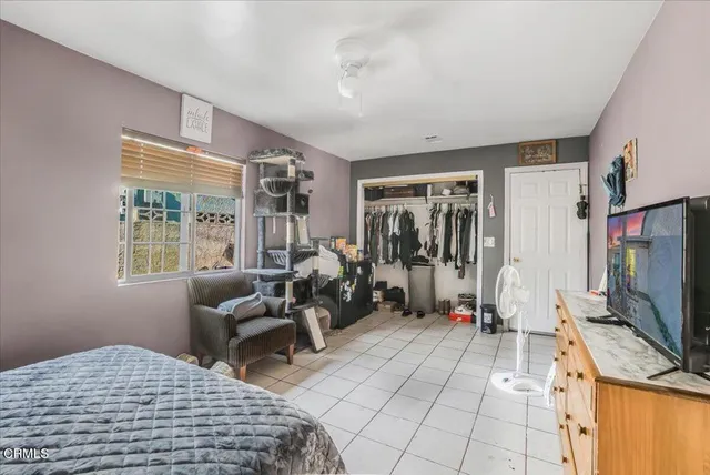 a bedroom with furniture and a flat screen tv