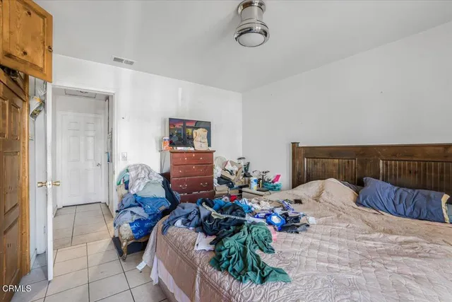 a bed room with a bed and a potted plant