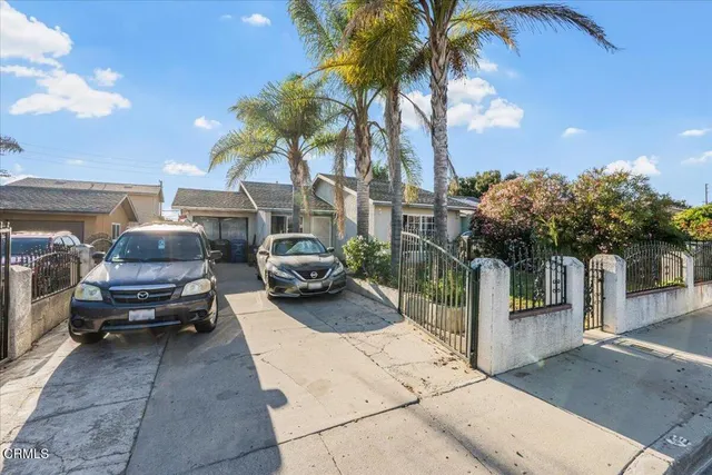a couple of cars parked in front of a house