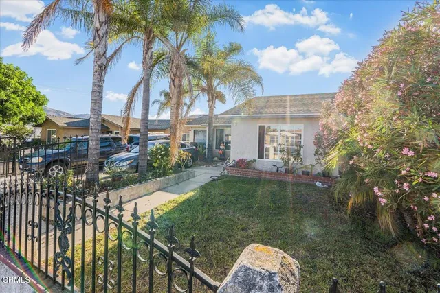 a backyard of a house with table and chairs