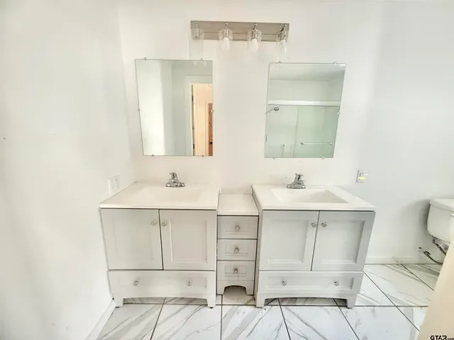 a bathroom with a sink vanity and mirror
