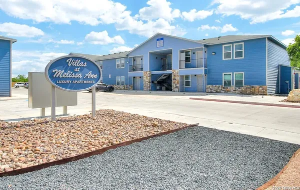 a front view of a house with a sign board