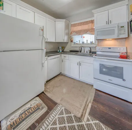 a kitchen with a cabinets and white appliances