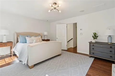 a bedroom with a bed and cabinet