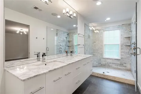 a bathroom with a granite countertop sink mirror and double