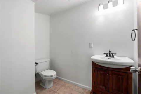 a bathroom with a sink toilet and mirror