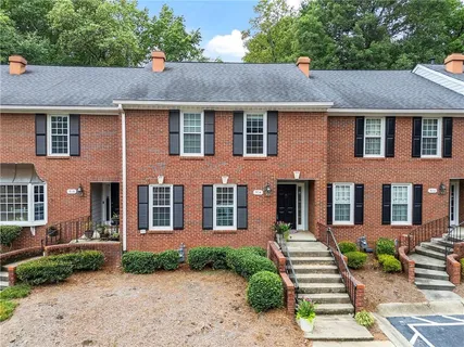 a aerial view of a brick house next to a yard